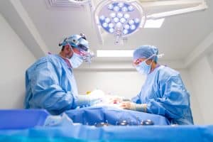 vets during surgery scrubbed up