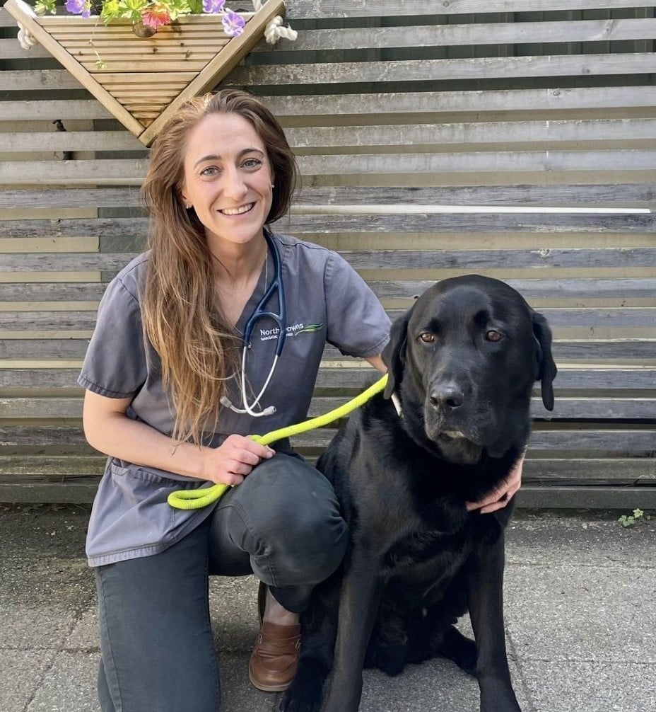 Full body photo of Heather Williams from NDSR next to a black labrador